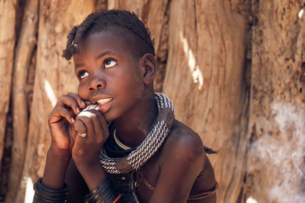 A thoughtful child with traditional attire reflects cultural heritage.