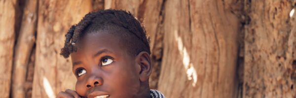 pexels-photo-21675772-21675772 A thoughtful child with traditional attire reflects cultural heritage.
